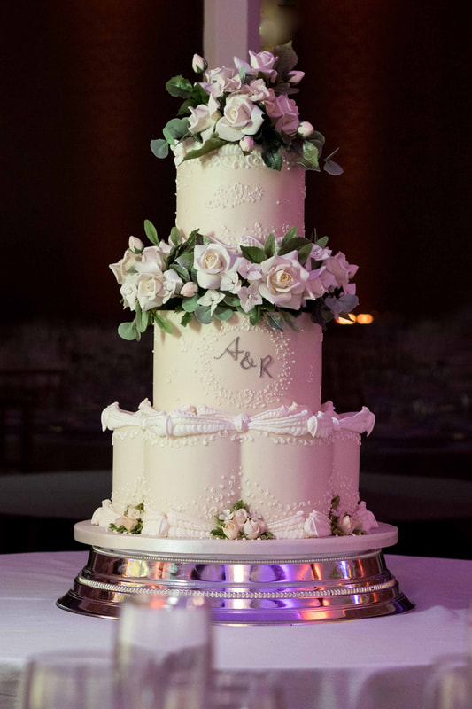three tier royal iced wedding cake with ugar flowers and petal base at Colshaw Hall, Cheshire