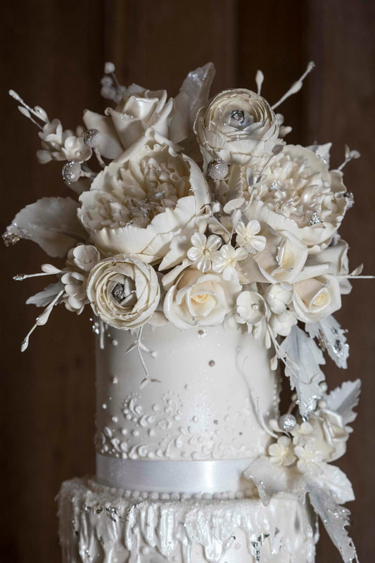 Silver and white sugar flowers for wedding cake at Abbey House Hotel in the Lake District