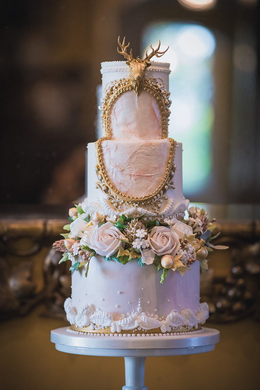 3 tier majestic wedding cake with gold stag head and frame with sugar  flowers 26