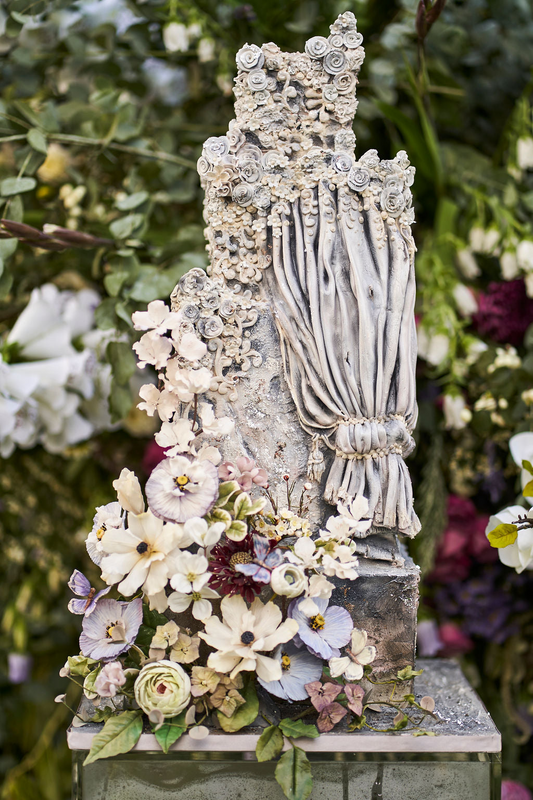 stunning 4 tier stone wedding cake with stone flower detailing, gold leaf, and sugar flowers 17