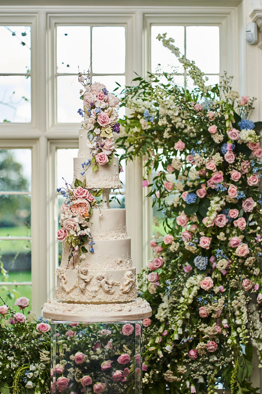 6 tier floral white wedding cake with cherubs, columns, and sugar flowers 11