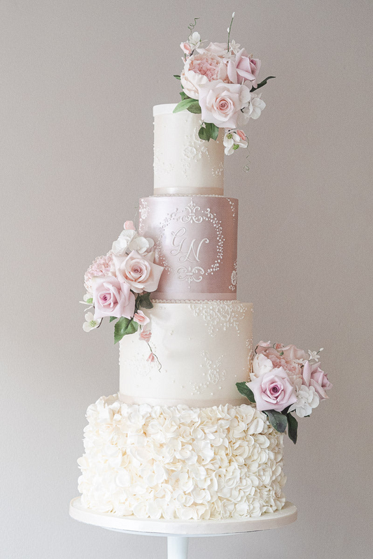 4 tier white and pink pretty textured wedding cake with pink and white sugar flowers and white monogram 14