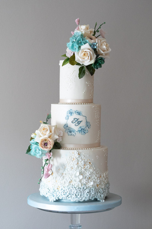 3 tier cool blue and white wedding cake with hand piped blue and white texture, blue and white sugar flowers and blue mongram 32