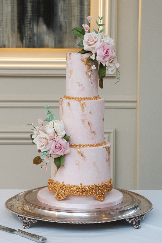 3 tier pink modern wedding cake with gold leaf marbling, hand piped gold details and pastel sugar flowers 11