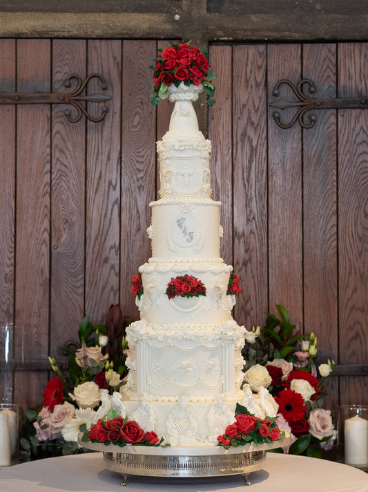 5 tier gothic white wedding cake white white textured details and red roses 5