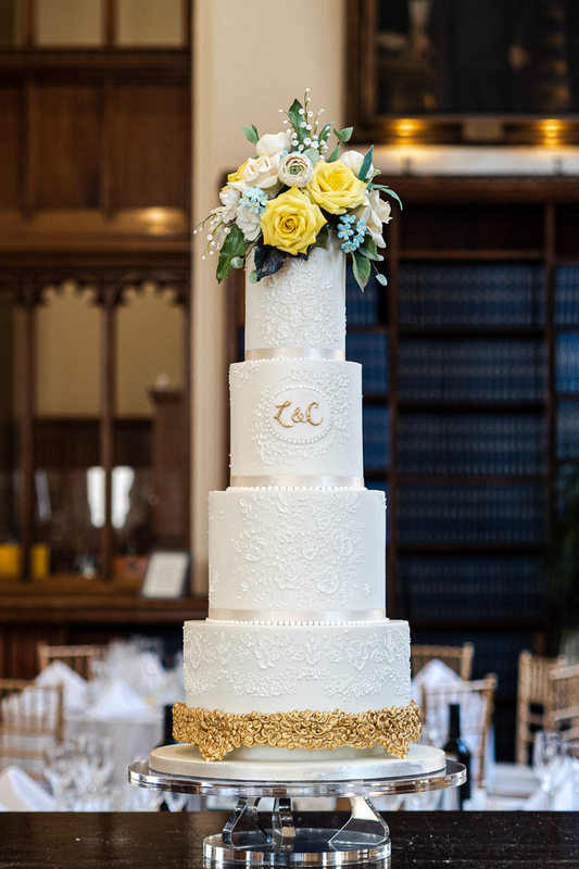 4 tier white dramatic textured wedding cake with hand piped gold details, sugar flowers and monogram  14