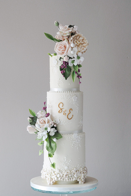 3 tier white textured slim wedding cake, with sugar flowers and gold monogram 23