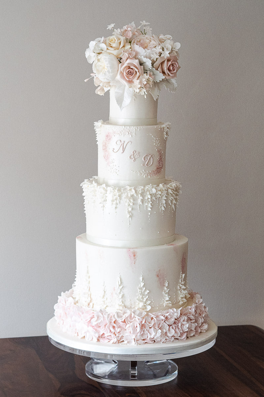 4 tier white beautiful wedding cake with pink ruffles, pink monogram and sugar flowers 32