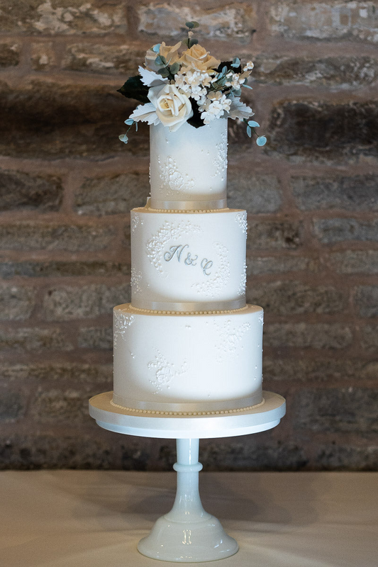 3 tier white beautiful wedding cake with silver monogram and sugar flowers 47