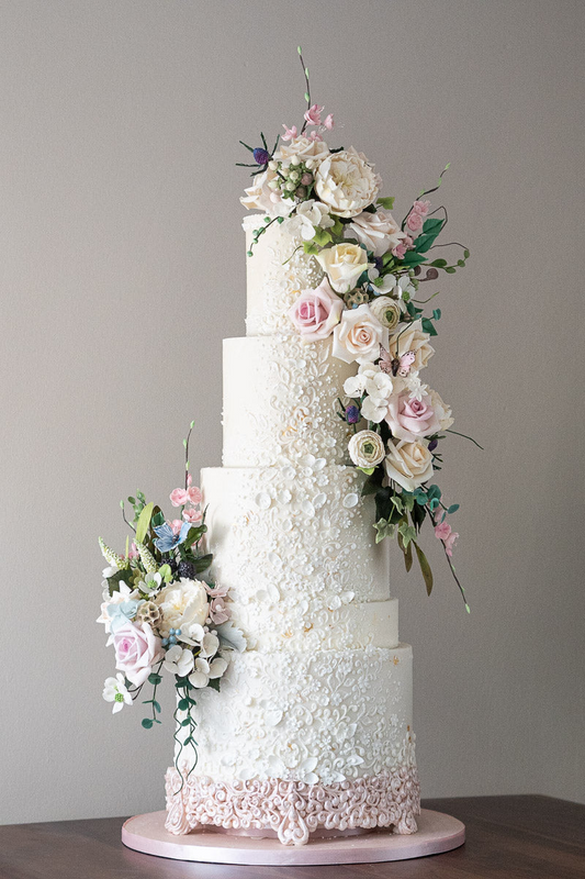 4 tier white textured stunning wedding cake with white petal details and cascading sugar flowers 29